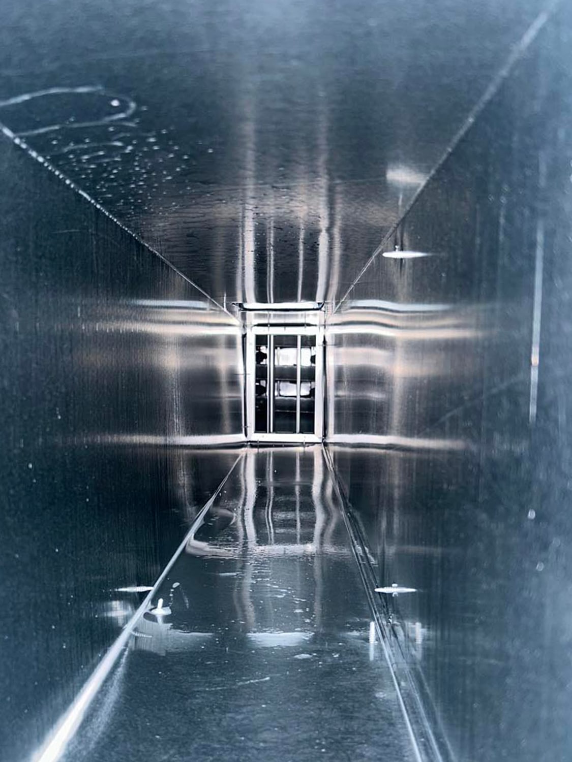 Interior view of a clean, shiny duct showcasing the effectiveness of 800 Duct's air duct cleaning services.